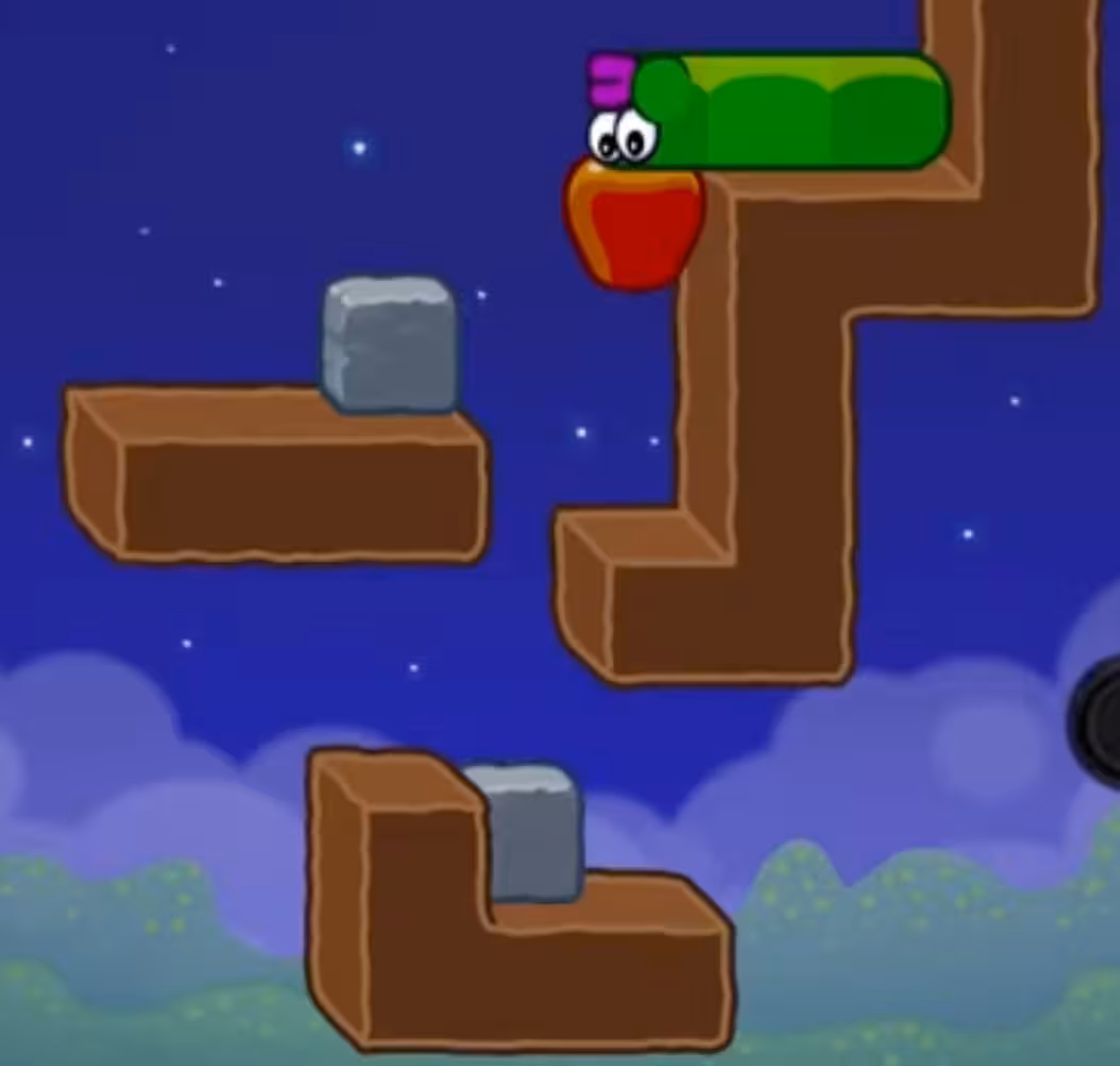 Apple Worm Level 17 Step 4: Push the right-side stone block left two steps to trigger a drop onto the lower dirt block