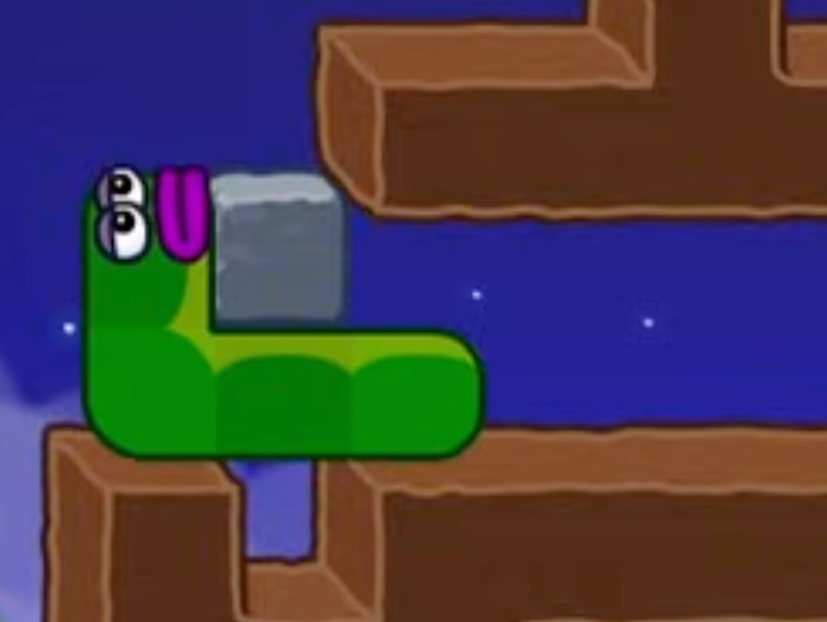 Apple Worm Level 20 Step 6: Let the worm naturally drop and wedge the stone so it doesn’t fall into the pit